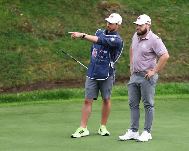 A stern-faced Tyrrell Hatton listens to his caddie Hugo Dodson during the first round of the Betfred British Masters hosted by Sir Nick Faldo at The Belfry. Picture: Luke Walker/Getty Images.