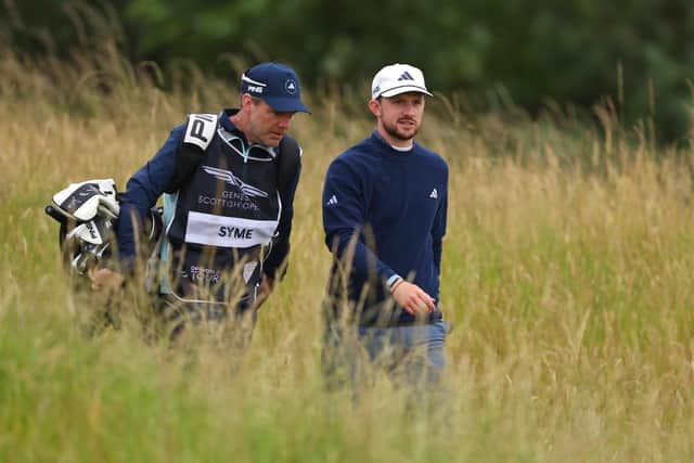 Connor Syme walks alongside his caddie, Ryan McGuigan during day one of the Genesis Scottish Open at The Renaissance Club. Picture: Andrew Redington/Getty Images.