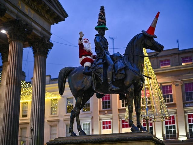 'Santa Claus' scales the Duke of Wellington statue in Glasgow in 2021.