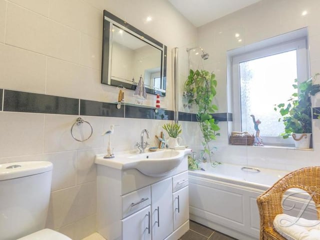 The family bathroom is delightful. It boasts a fitted bath with overhead shower, hand wash basin with storage, low-flush WC and full-height tiling.
