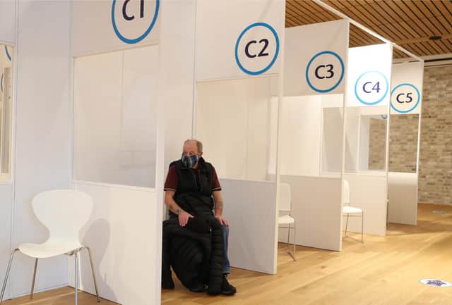 A patient sits in the observation area after receiving a Covid-19 vaccine at the Royal Highland Showground near Edinburgh. Picture date: Thursday February 4, 2021.