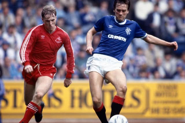 Bell contests the ball with Stuart McKimmie after he swapped sides in the great rivalry and joined Rangers.