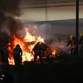 Fire marshals put out a fire on French driver Romain Grosjean's Haas car during the Bahrain Grand Prix.