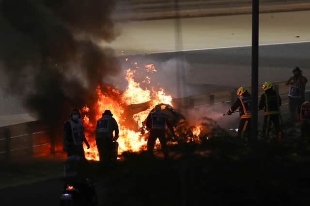 Fire marshals put out a fire on French driver Romain Grosjean's Haas car during the Bahrain Grand Prix.