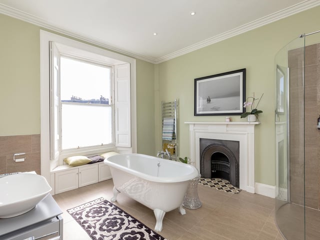 The elegant family bathroom is well appointed and features a free-standing bath