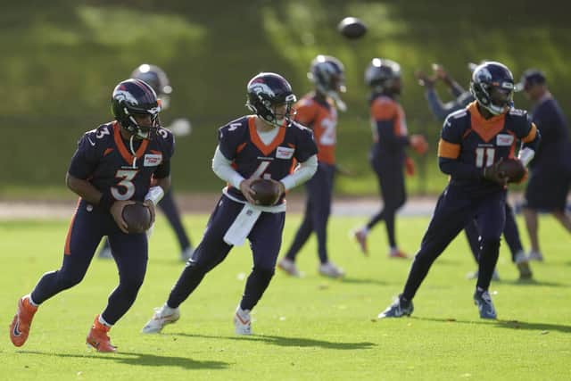 Denver Broncos quarterbacks, Russell Wilson, Brett Rypien and Josh Johnson, attend a practice session in Harrow, England.