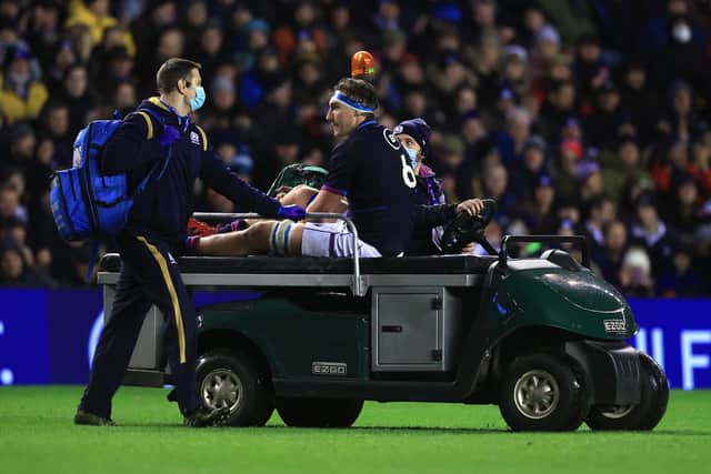 Jamie Ritchie is carried off the pitch after injuring his hamstring against England. (Photo by David Rogers/Getty Images)