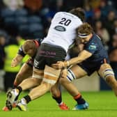 Edinburgh's Jamie Ritchie and Tom Cruse tackle Glasgow Warriors' Lewis Bean during a BKT United Rugby Championship match between Edinburgh and Glasgow Warriors at BT Murrayfield.