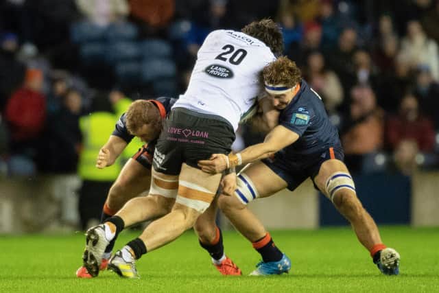Edinburgh's Jamie Ritchie and Tom Cruse tackle Glasgow Warriors' Lewis Bean during a BKT United Rugby Championship match between Edinburgh and Glasgow Warriors at BT Murrayfield.