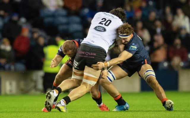 Edinburgh's Jamie Ritchie and Tom Cruse tackle Glasgow Warriors' Lewis Bean during a BKT United Rugby Championship match between Edinburgh and Glasgow Warriors at BT Murrayfield.