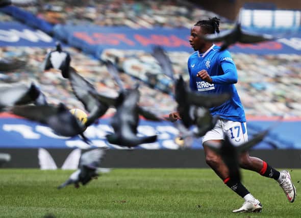 Joe Aribo of Rangers controls the ball as flock of Pigeons fly past during the Ladbrokes Scottish Premier League match between Rangers and Dundee United at Ibrox Stadium on February 21, 2021 in Glasgow, Scotland. (Photo by Ian MacNicol/Getty Images)