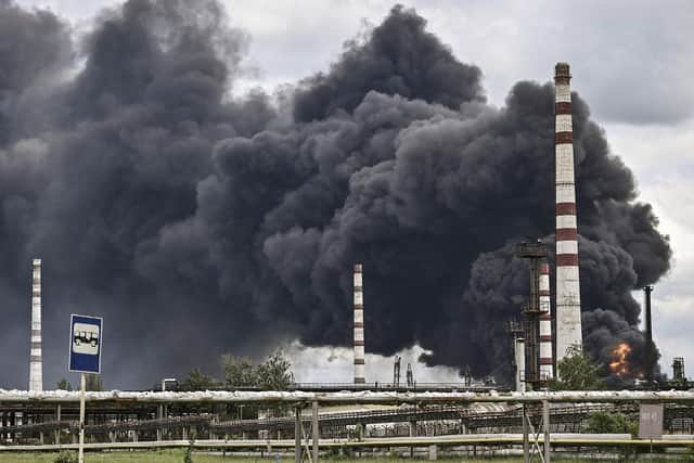 Smoke rises from an oil refinery after an attack outside the city of Lysychansk in the eastern Ukranian region of Donbas, on May 22, 2022, on the 88th day of the Russian invasion of Ukraine. (Photo by ARIS MESSINIS via Getty Images)
