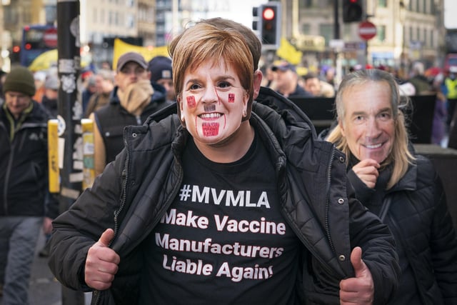 One protester wearing a Nicola Sturgeon mask and a T-shirt which reads: "Make vaccine manufacturers liable again!"