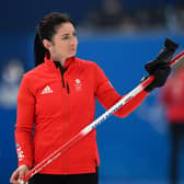 Eve Muirhead acknowledges Team GB supporters during the win over Japan at the National Aquatics Centre in Beijing. (Photo by LILLIAN SUWANRUMPHA/AFP via Getty Images)