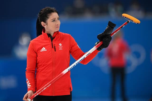 Eve Muirhead acknowledges Team GB supporters during the win over Japan at the National Aquatics Centre in Beijing. (Photo by LILLIAN SUWANRUMPHA/AFP via Getty Images)