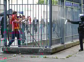 Police spray tear gas at Liverpool fans outside the stadium ahead of the Champions League final between Liverpool and Real Madrid (Picture: Matthias Hangst/Getty Images)