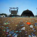 The clean up operation by the Pyramid Stage begins in a field covered in litter at the end of the Glastonbury Festival at Worthy Farm in Somerset. Picture: Ben Birchall/PA Wire