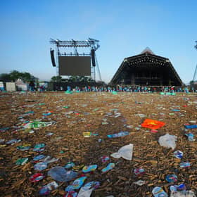 The clean up operation by the Pyramid Stage begins in a field covered in litter at the end of the Glastonbury Festival at Worthy Farm in Somerset. Picture: Ben Birchall/PA Wire