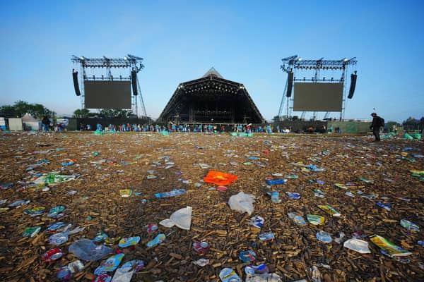 The clean up operation by the Pyramid Stage begins in a field covered in litter at the end of the Glastonbury Festival at Worthy Farm in Somerset. Picture: Ben Birchall/PA Wire