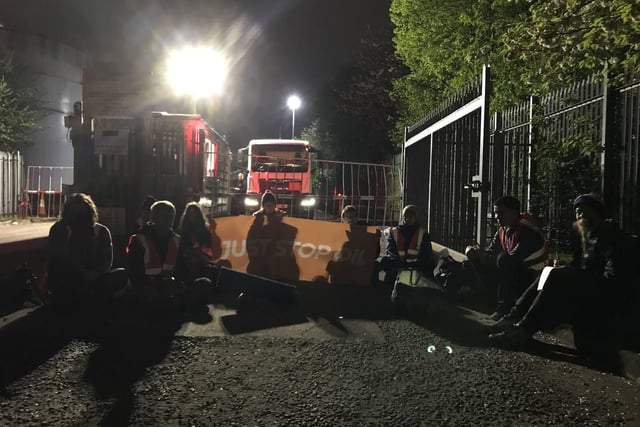 Handout photo issued by Just Stop Oil of campaigners staging a protest. Protesters blocked access to the Nustar Clydebank facility in West Dunbartonshire by climbing on top of tankers and locking on to the entrance at around 4am on Tuesday.
