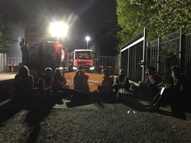 Handout photo issued by Just Stop Oil of campaigners staging a protest. Protesters blocked access to the Nustar Clydebank facility in West Dunbartonshire by climbing on top of tankers and locking on to the entrance at around 4am on Tuesday.