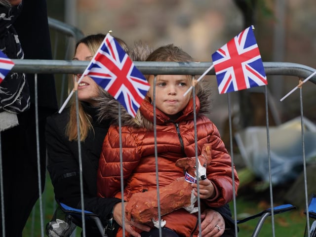 Members of the public line the streets in Ballater ahead of the hearse carrying the coffin of Queen Elizabeth passing through the town (Pic: PA/Andrew Milligan)