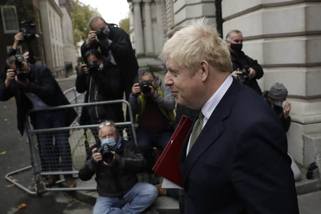 In a blow to Boris Johnson's government, credit agency Moody's has announced that it is downgrading Britain’s credit rating, partly because of the 'weakening in the UK's institutions and governance' in recent years (Picture: Matt Dunham/AP)