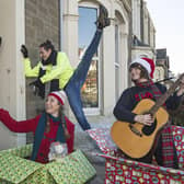 Actors Emily Winter and Leah Byrne from Dundee Rep Ensemble and dancer Oscar Perez of Scottish Dance Theatre make a surprise appearance on a doorstep in Broughty Ferry (Picture: Neil Hanna/PA Wire)