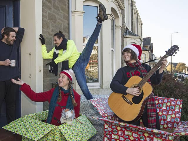 Actors Emily Winter and Leah Byrne from Dundee Rep Ensemble and dancer Oscar Perez of Scottish Dance Theatre make a surprise appearance on a doorstep in Broughty Ferry (Picture: Neil Hanna/PA Wire)