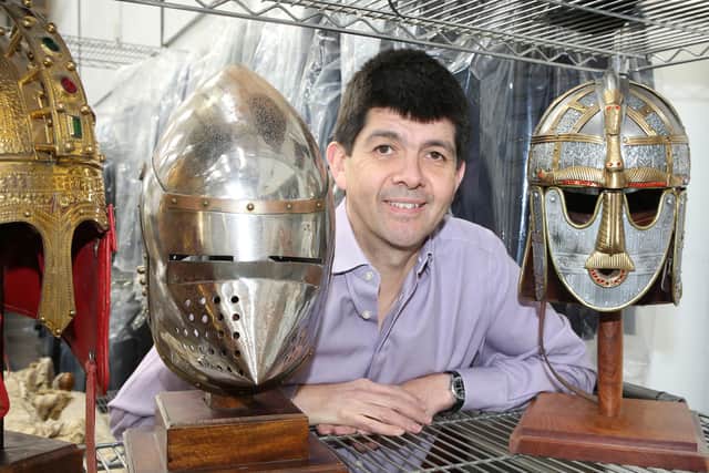 Paul Cooper with some of the reproductions of historic helmets that adorned the walls