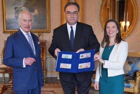 King Charles is presented with the first bank notes featuring his portrait by Bank of England Governor Andrew Bailey and Sarah John, the bank's chief cashier (Picture: Yui Mok/WPA pool/Getty Images)