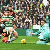 Benjamin Siegrist displays the form for Dundee United which earned him a move to Celtic, making a save from striker Giorgos Giakoumakis at Celtic Park in January. (Photo by Mark Runnacles/Getty Images)
