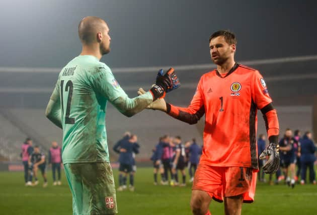 Scotland hero David Marshall consoles his Serbian counterpart Pedrag Rajkovic.