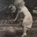 The faded black and white photograph of Susan Dalgety playing football as a toddler which makes her look to the past - but also the future. PIC: Contributed.