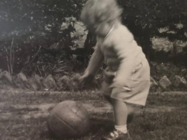 The faded black and white photograph of Susan Dalgety playing football as a toddler which makes her look to the past - but also the future. PIC: Contributed.