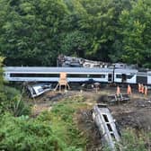 The driver's cab and front section of the High Speed Train in the Carmont crash is in the bottom right of the picture, partially concealed by undergrowth. (Photo by John Devlin)