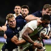 France's flanker Cameron Woki (C) is tackled by Scotland's wing Duhan van der Merwe during the match in Saint-Etienne.