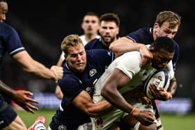 France's flanker Cameron Woki (C) is tackled by Scotland's wing Duhan van der Merwe during the match in Saint-Etienne.