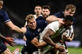 France's flanker Cameron Woki (C) is tackled by Scotland's wing Duhan van der Merwe during the match in Saint-Etienne.