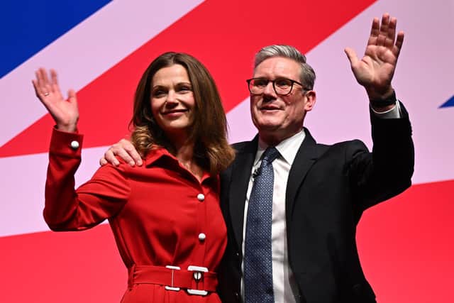 Prime Minister Keir Starmer waves as he stands with his wife Victoria