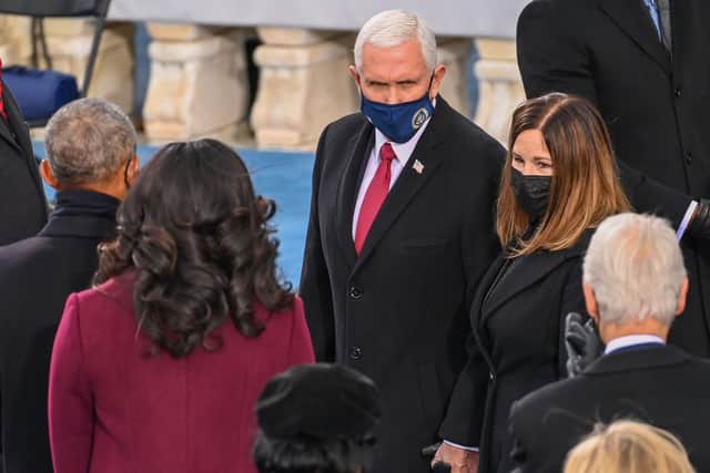 Former US Vice-President Mike Pence and his wife Karen Pence, facing camera, speak to former President Barack Obama and his wife Michelle Obama (Picture: Saul Loeb/pool/AFP via Getty Images)