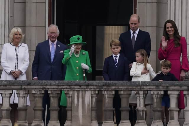 Queen Elizabeth II waves to the crowd during the Platinum Jubilee Pageant outside Buckingham Palace in London, Sunday, June 5, 2022, on the last of four days of celebrations to mark the Platinum Jubilee. The pageant will be a carnival procession up The Mall featuring giant puppets and celebrities that will depict key moments from the Queen Elizabeth II's seven decades on the throne. (AP Photo/Alberto Pezzali, Pool)