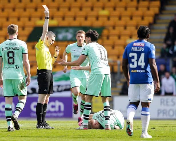 Referee Craig Napier shows Hibs' James Jeggo a red card during the match against St Johnstone.