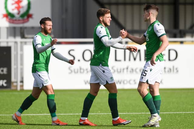 Hibernian's Jamie Gullan celebrates making it 1-1 with matchwinner Kevin Nisbet and Martin Boyle during their Betfred Cup against Cove Rangers. Photo by Ross MacDonald / SNS Group