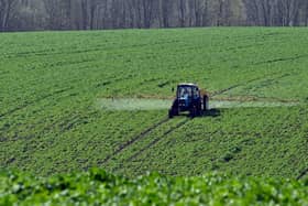 A farmer rides a floater truck spraying fertilisers