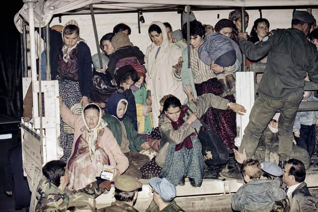 Evacuees form the besieged Bosnian town of Srebrenica jump off a U.N. truck after arriving in Tuzla, after a tense journey across the most contested battle lines in Bosnia.  .(AP Photo/Michel Euler, File)