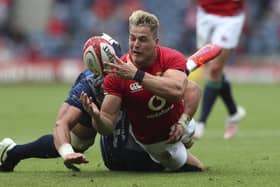 Duhan van der Merwe, who scored a try on his Lions debut, is tackled by Japan's Lappies Labuschagne.