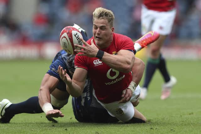 Duhan van der Merwe, who scored a try on his Lions debut, is tackled by Japan's Lappies Labuschagne.
