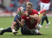 Duhan van der Merwe, who scored a try on his Lions debut, is tackled by Japan's Lappies Labuschagne.