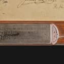 A little plaque details the origins of the frame, which was made from the wood of the HMS Challenger mast. PIC: NMS.
